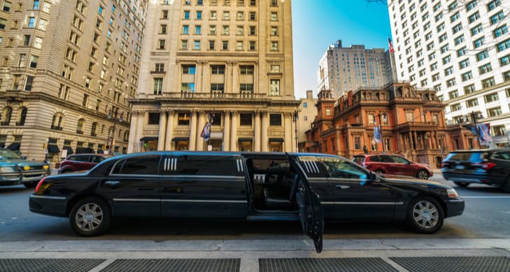 A black stretch limo parked on a street