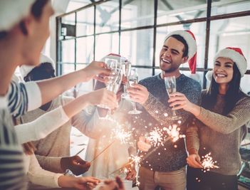 colleagues cheering and celebrating christmas at a party