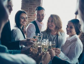 corporate team clinking glasses at a company party