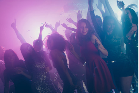 teens dancing under lights at a formal dance